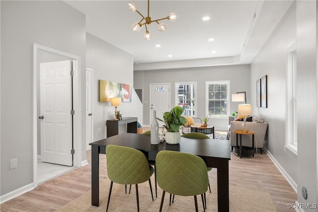 dining space with a notable chandelier, baseboards, light wood-style floors, and recessed lighting