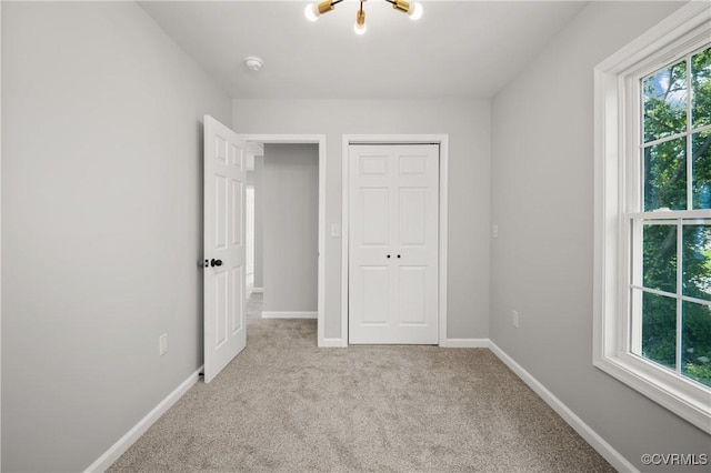 unfurnished bedroom featuring baseboards, a closet, and carpet