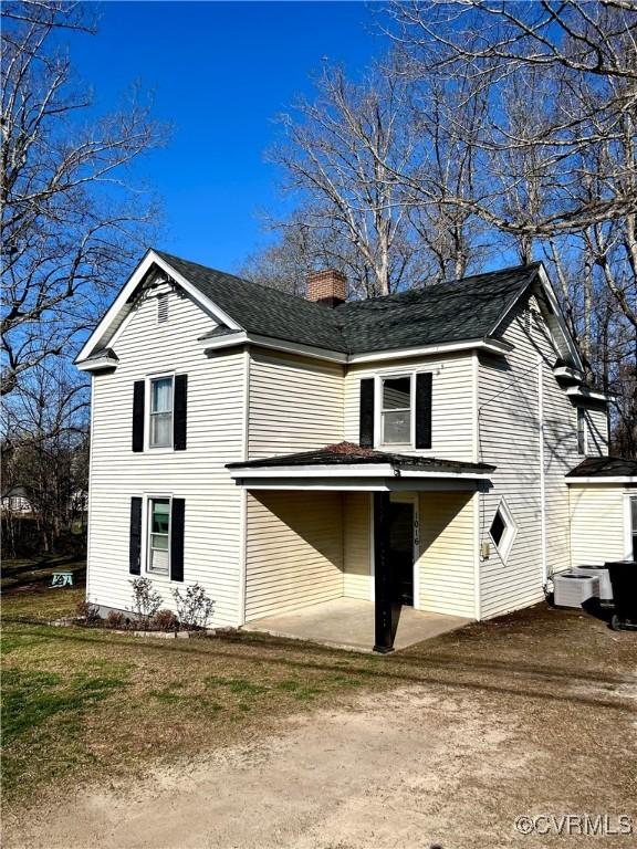 1016 Court St, Victoria, VA 23974 - back of property featuring central air condition unit, a patio, and a chimney