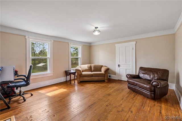 1016 Court St, Victoria, VA 23974 - living area with light wood-type flooring, baseboards, and ornamental molding