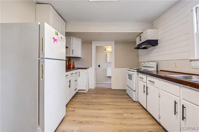1016 Court St, Victoria, VA 23974 - kitchen featuring white cabinetry, dark countertops, white appliances, and light wood finished floors
