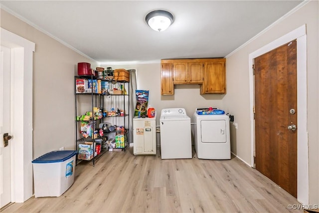 1016 Court St, Victoria, VA 23974 - laundry room with light wood-style flooring, independent washer and dryer, ornamental molding, and cabinet space
