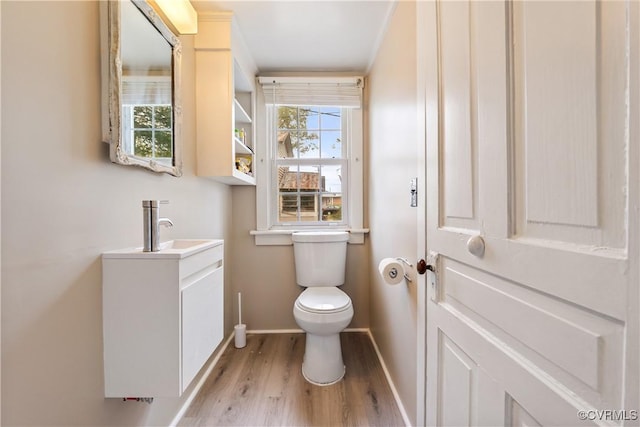 1016 Court St, Victoria, VA 23974 - bathroom with vanity, baseboards, toilet, and wood finished floors