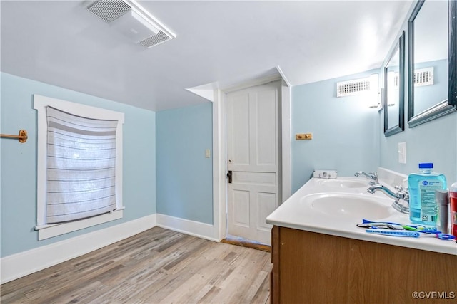 1016 Court St, Victoria, VA 23974 - full bathroom with visible vents, baseboards, a sink, and wood finished floors