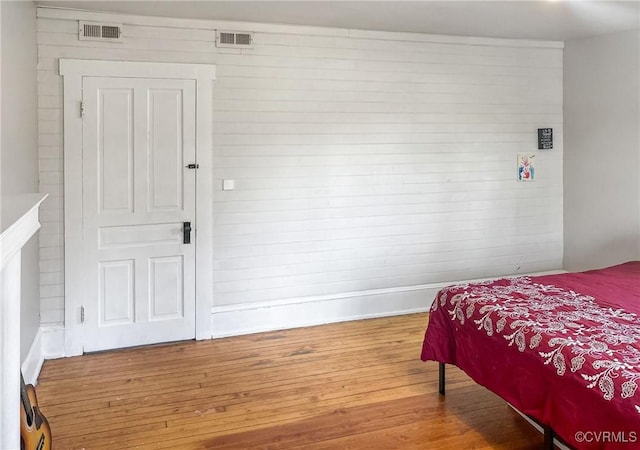 1016 Court St, Victoria, VA 23974 - bedroom featuring wood walls, visible vents, baseboards, and wood finished floors