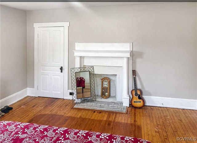 1016 Court St, Victoria, VA 23974 - unfurnished living room with a fireplace, baseboards, and hardwood / wood-style flooring