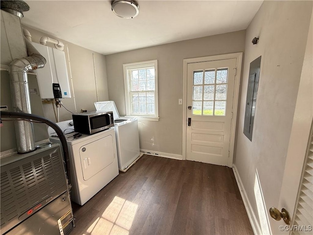 laundry area with laundry area, electric panel, dark wood-style flooring, washer and dryer, and baseboards