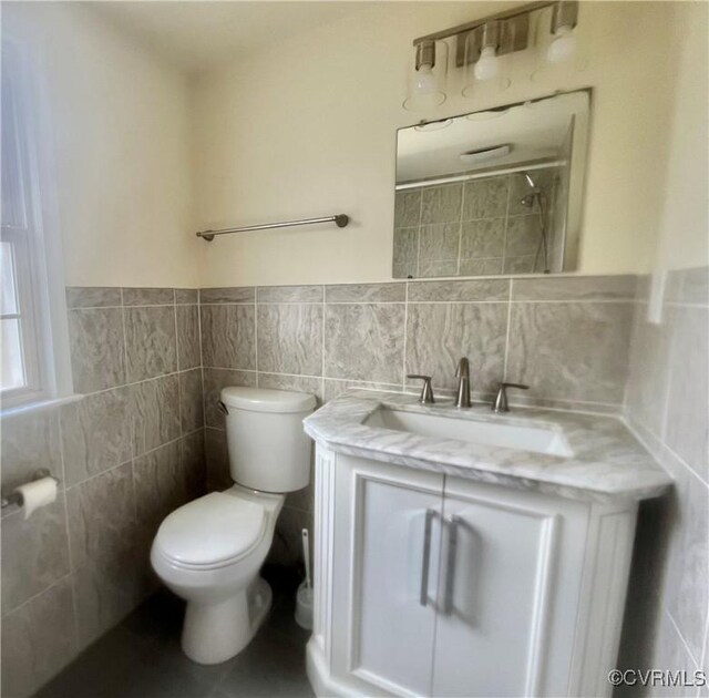 309 Royal Oak Ave, Colonial Heights, VA 23834 - bathroom featuring tile walls, vanity, a shower, and wainscoting