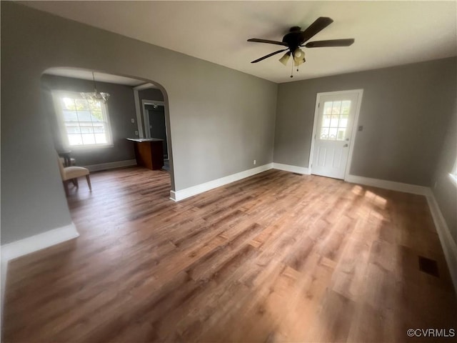 309 Royal Oak Ave, Colonial Heights, VA 23834 - unfurnished room with arched walkways, plenty of natural light, wood finished floors, and a ceiling fan