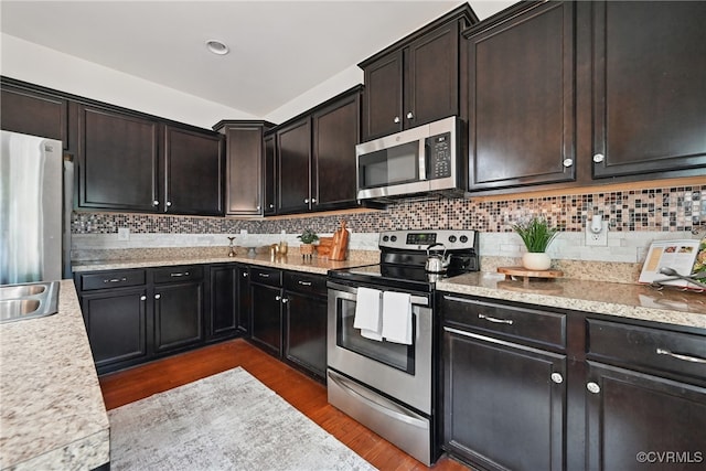 11418 Parrish Creek Ln, Chesterfield, VA 23832 - kitchen featuring appliances with stainless steel finishes, dark wood-style flooring, light countertops, and backsplash
