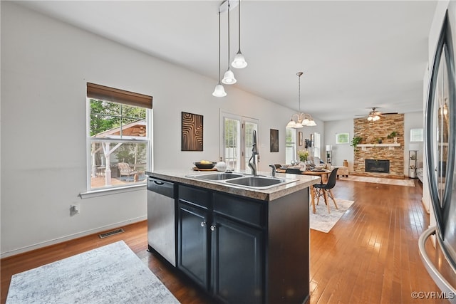 11418 Parrish Creek Ln, Chesterfield, VA 23832 - kitchen with appliances with stainless steel finishes, a stone fireplace, plenty of natural light, and dark cabinets