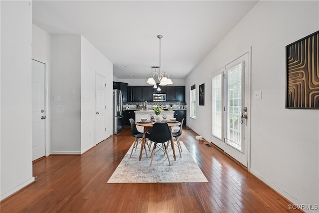 11418 Parrish Creek Ln, Chesterfield, VA 23832 - dining space featuring a chandelier, dark wood-type flooring, and baseboards