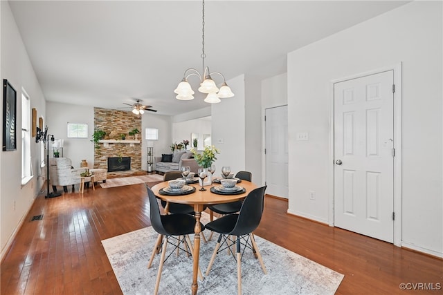 11418 Parrish Creek Ln, Chesterfield, VA 23832 - dining room featuring hardwood / wood-style flooring, a fireplace, ceiling fan, a chandelier, and baseboards