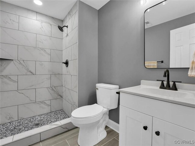3519 Murchies Hill Rd, Chesterfield, VA 23234 - full bathroom featuring a tile shower, toilet, vanity, baseboards, and wood tiled floor
