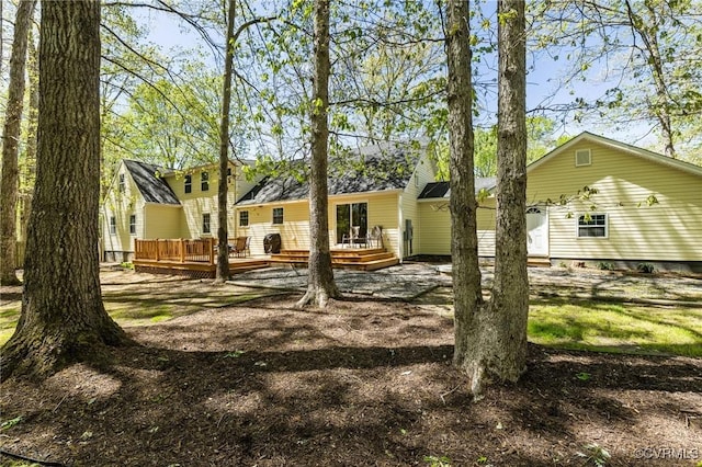 back of property featuring a wooden deck