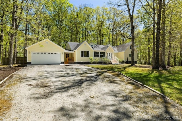 single story home featuring driveway, fence, a garage, and a front yard