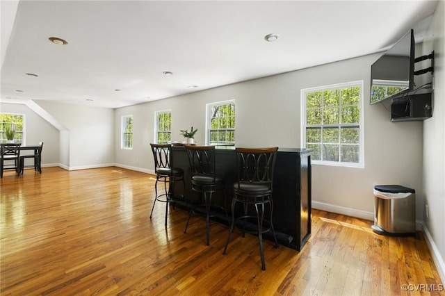 bar featuring recessed lighting, light wood-style floors, a dry bar, and baseboards