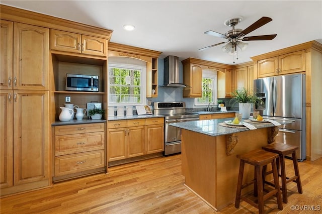 kitchen with open shelves, plenty of natural light, wall chimney exhaust hood, and appliances with stainless steel finishes