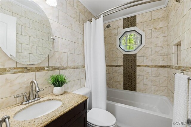 bathroom featuring toilet, tile walls, backsplash, shower / tub combo with curtain, and vanity