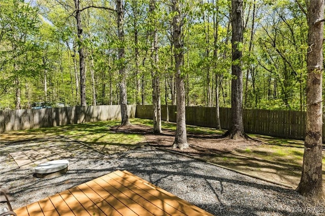 view of yard with a fenced backyard and a deck