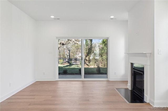 124 Steyland St, Ashland, VA 23005 - unfurnished living room featuring a glass covered fireplace, wood finished floors, recessed lighting, and baseboards