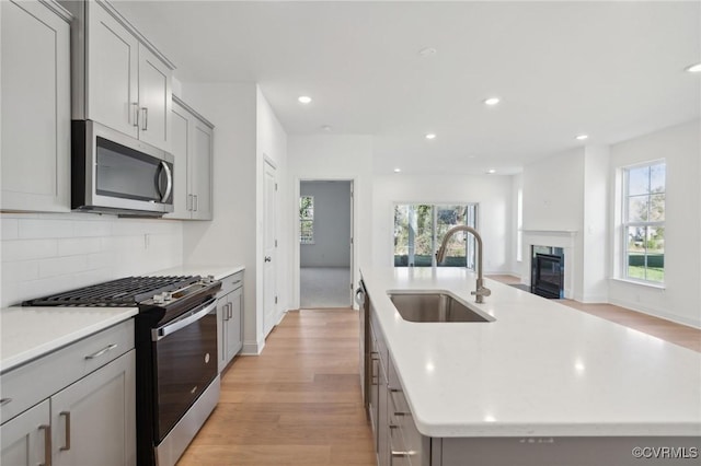 124 Steyland St, Ashland, VA 23005 - kitchen with stainless steel microwave, gas range, a sink, gray cabinets, and recessed lighting