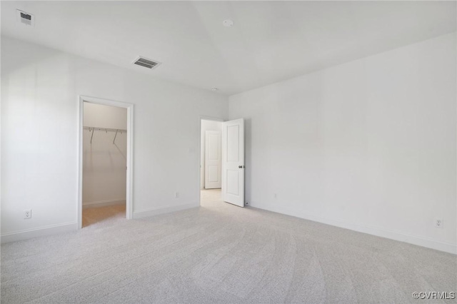 124 Steyland St, Ashland, VA 23005 - unfurnished bedroom with light carpet, a walk in closet, baseboards, and a closet