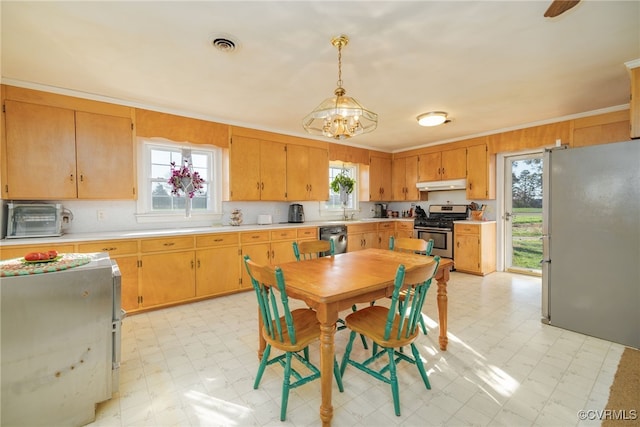 kitchen featuring under cabinet range hood, light countertops, stainless steel appliances, and light floors