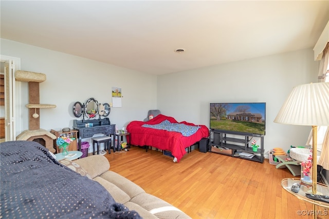 bedroom with visible vents and wood finished floors