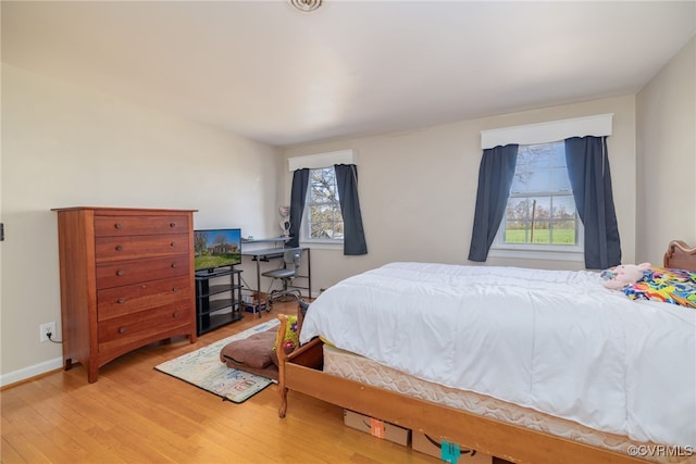 bedroom featuring baseboards and light wood-style floors