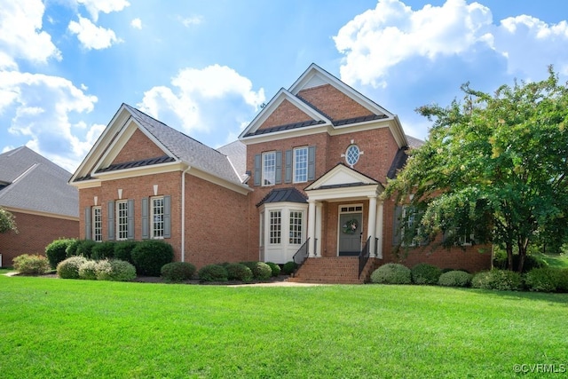 view of front of property with brick siding and a front lawn