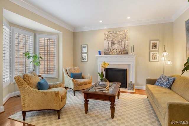 living area with light wood-style flooring, crown molding, and a healthy amount of sunlight