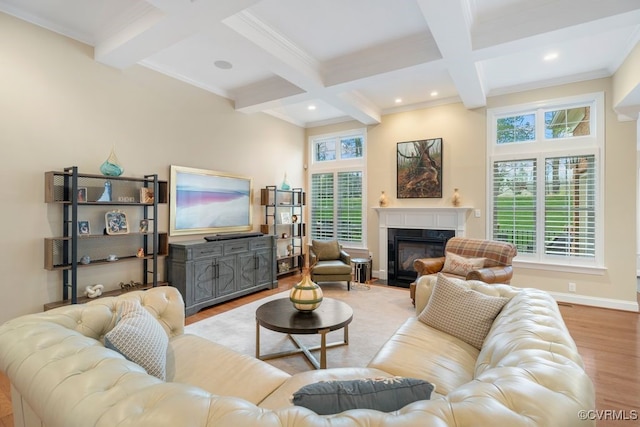 living room featuring a premium fireplace, beamed ceiling, ornamental molding, wood finished floors, and coffered ceiling
