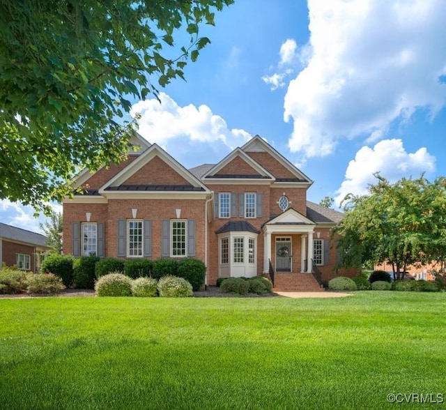 view of front facade featuring brick siding and a front lawn