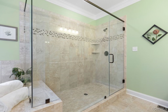 full bathroom featuring crown molding, baseboards, and a stall shower