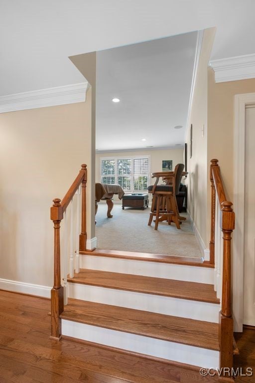staircase with recessed lighting, baseboards, crown molding, and wood finished floors