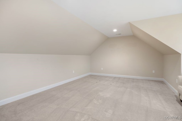 additional living space with baseboards, recessed lighting, light carpet, and lofted ceiling