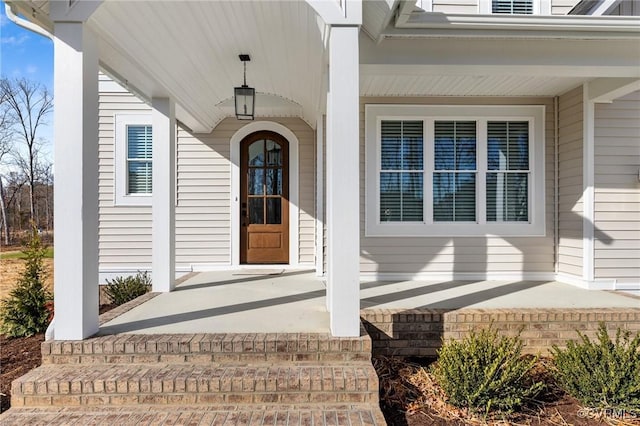view of exterior entry with a porch