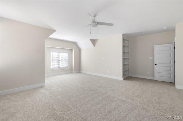 spare room featuring carpet flooring, baseboards, and ceiling fan