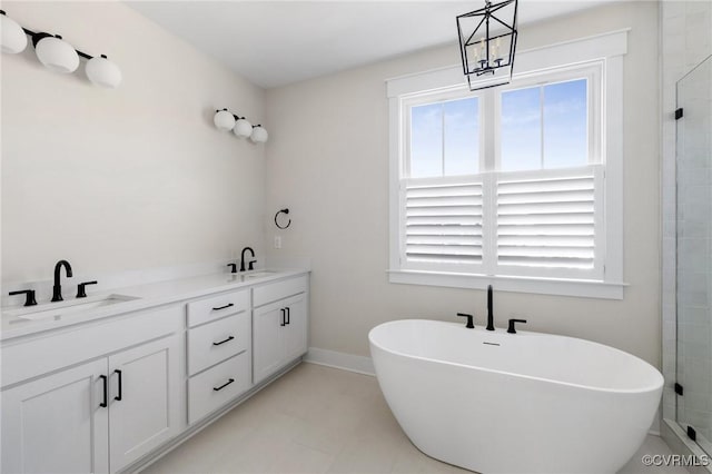 full bath with a soaking tub, a sink, and plenty of natural light