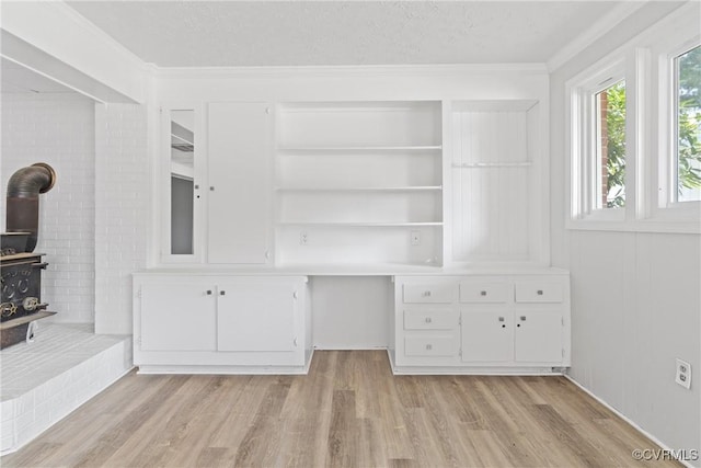 201 Winston Ave, Colonial Heights, VA 23834 - interior space with a wood stove, light wood-style flooring, ornamental molding, and a textured ceiling