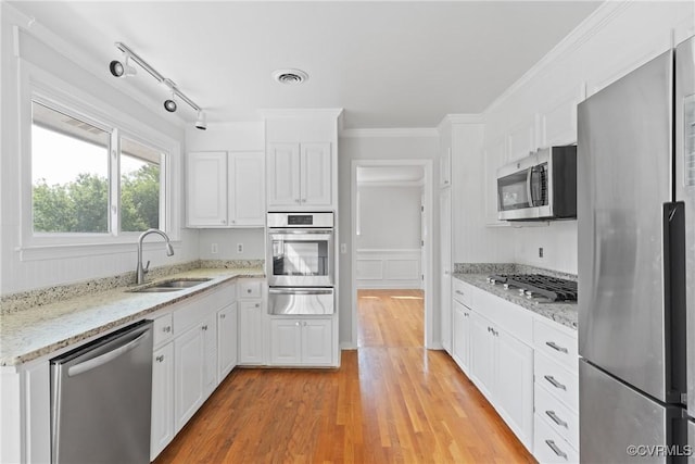 201 Winston Ave, Colonial Heights, VA 23834 - kitchen featuring appliances with stainless steel finishes, a sink, a warming drawer, white cabinetry, and light wood-style floors