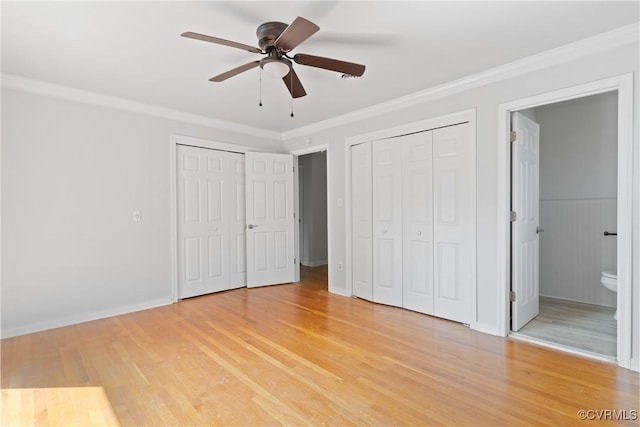 201 Winston Ave, Colonial Heights, VA 23834 - unfurnished bedroom with multiple closets, light wood finished floors, crown molding, connected bathroom, and a ceiling fan