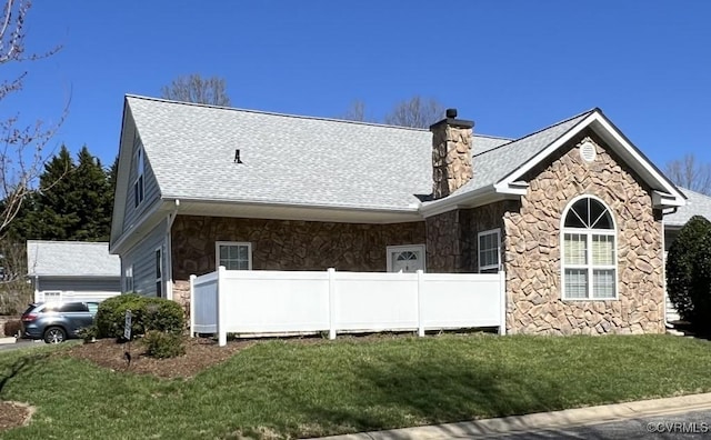 2566 Wanstead Ct, Richmond, VA 23238 - view of front facade with a chimney, a shingled roof, a front lawn, and stone siding