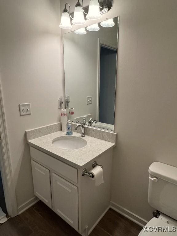 2566 Wanstead Ct, Richmond, VA 23238 - half bathroom with wood finished floors, vanity, baseboards, toilet, and a chandelier