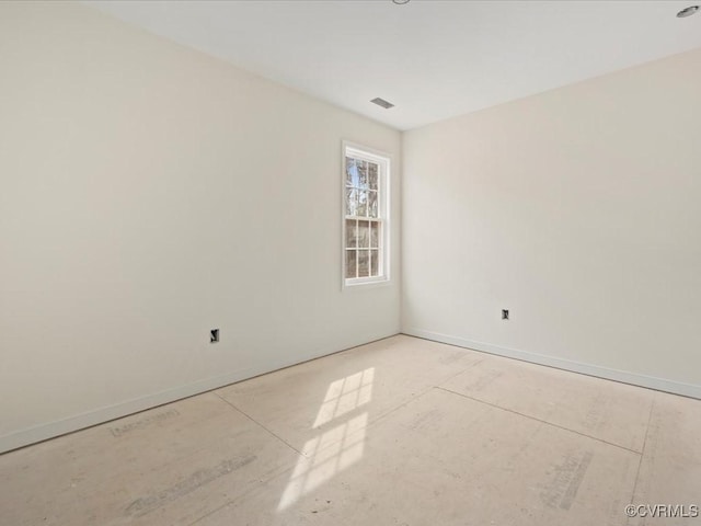 unfurnished room with baseboards and visible vents