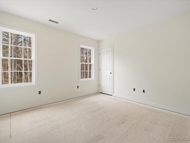 empty room featuring baseboards and visible vents