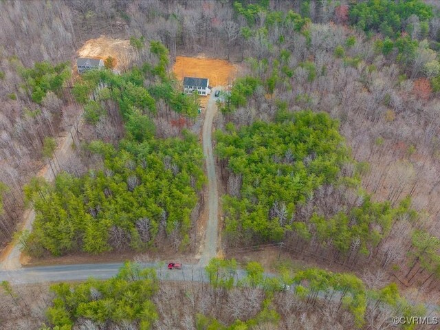 bird's eye view with a wooded view