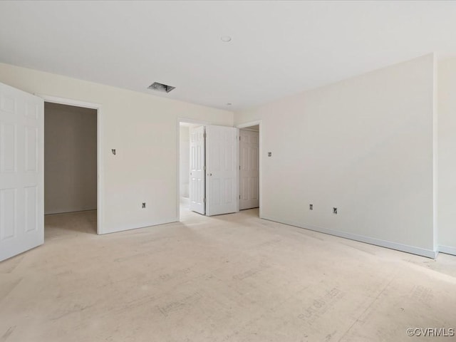 unfurnished room featuring visible vents