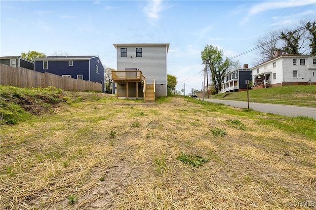 view of yard with fence and a deck